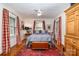 Bedroom featuring hardwood floors, a ceiling fan, and plentiful natural light from the two windows at 2120 Malvern Rd, Charlotte, NC 28207