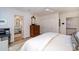 Bright bedroom featuring hardwood floors, soft lighting, and access to an ensuite bathroom and the upper floor at 2120 Malvern Rd, Charlotte, NC 28207