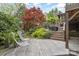 Wooden deck featuring modern furniture and a view of the wooded backyard with stairs leading up to it at 2120 Malvern Rd, Charlotte, NC 28207