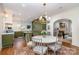 Open-concept dining area featuring a chandelier, rug, and seamless flow into the gourmet kitchen and living space at 2120 Malvern Rd, Charlotte, NC 28207