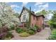 Beautiful brick home with manicured landscaping, brick driveway, and detached garage at 2120 Malvern Rd, Charlotte, NC 28207