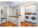 Hallway featuring a view to a laundry room with a modern washer and dryer, and a bathroom at 2120 Malvern Rd, Charlotte, NC 28207