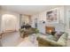 Inviting living room featuring a brick fireplace, neutral carpet, and elegant decor at 2120 Malvern Rd, Charlotte, NC 28207