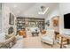Open-concept living room boasts a vaulted ceiling, built-in shelving, a skylight, and an archway to the dining area at 2120 Malvern Rd, Charlotte, NC 28207