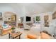 Open-concept living room with a vaulted ceiling, and access to the deck and dining area with an olive kitchen at 2120 Malvern Rd, Charlotte, NC 28207