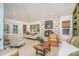 Bright living room features a stone fireplace, vaulted ceiling, built-in shelving, and French doors to the backyard at 2120 Malvern Rd, Charlotte, NC 28207