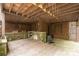 An outdoor kitchen is beneath a covered area with wood flooring, a stone countertop, and wood trellis walls at 2120 Malvern Rd, Charlotte, NC 28207