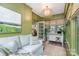 Cozy sunroom with ample natural light, green accents, and stylish furnishings at 2120 Malvern Rd, Charlotte, NC 28207