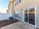 A fenced backyard has a concrete patio and sliding glass doors leading into the home at 2240 Kensington Station Pkwy, Charlotte, NC 28210