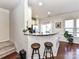 Well-lit kitchen with white cabinets, a breakfast bar, and stainless steel appliances at 2240 Kensington Station Pkwy, Charlotte, NC 28210