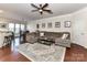 Bright living room connected to the dining area, featuring a large sofa and hardwood floors at 2240 Kensington Station Pkwy, Charlotte, NC 28210