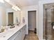 Main bathroom with double sink vanity and tiled walk-in shower at 2240 Kensington Station Pkwy, Charlotte, NC 28210
