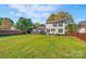 Large level backyard with wood fence, covered deck and patio for enjoying outdoor living at 2243 Flint Glenn Ln, Charlotte, NC 28262
