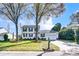 Traditional two-story home with white siding, black shutters, and a well-manicured front lawn with mature trees at 2243 Flint Glenn Ln, Charlotte, NC 28262