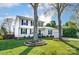 Charming two-story home with classic white siding, black shutters, and well-manicured lawn with mature trees at 2243 Flint Glenn Ln, Charlotte, NC 28262