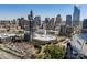 High-angle shot revealing a sprawling cityscape, featuring various buildings, a stadium, and lush greenery, showcasing the city's diversity at 230 S Tryon St # 610, Charlotte, NC 28202