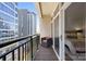 Cozy balcony with a chair and a view of the city, with sliding glass doors leading to the bedroom at 230 S Tryon St # 610, Charlotte, NC 28202