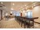 Modern bar with pendant lighting, bar seating, and light beige colored walls at 230 S Tryon St # 610, Charlotte, NC 28202