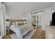 Comfortable bedroom featuring a large bed and a stylish sliding barn door to the bathroom at 230 S Tryon St # 610, Charlotte, NC 28202