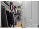 Spacious walk-in closet with ample hanging space and shelving for organized storage, with light wood flooring at 230 S Tryon St # 610, Charlotte, NC 28202