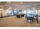 Bright game room featuring a pool table, tables, chairs, and large windows at 230 S Tryon St # 610, Charlotte, NC 28202