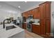 Well-equipped kitchen with stainless steel appliances and warm wood cabinetry at 230 S Tryon St # 610, Charlotte, NC 28202
