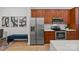 Modern kitchen with stainless steel appliances and warm wood cabinetry at 230 S Tryon St # 610, Charlotte, NC 28202