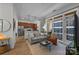 Bright living room featuring an open floor plan, hardwood floors, and a balcony with city views at 230 S Tryon St # 610, Charlotte, NC 28202