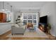 Cozy living room with hardwood floors, modern decor, and large windows offering cityscape views at 230 S Tryon St # 610, Charlotte, NC 28202