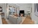 Bright living room featuring hardwood floors, large windows, and open access to a bedroom at 230 S Tryon St # 610, Charlotte, NC 28202
