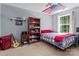 This ' bedroom showcases a cozy sleeping space and a shelf filled with personal items, under an American flag at 270 Almora Loop, Mooresville, NC 28115
