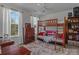 Bedroom with a wood bunk bed featuring a futon below, complimented by a dresser, soft rug, and natural light at 270 Almora Loop, Mooresville, NC 28115