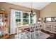 Bright dining room with a chandelier and large windows overlooking the yard at 270 Almora Loop, Mooresville, NC 28115
