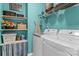 Bright laundry room with a modern washer and dryer, shelving, and decor at 270 Almora Loop, Mooresville, NC 28115