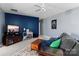 Living room features a navy accent wall, a media center, a plush grey sofa with colorful pillows, and a wooden coffee table at 270 Almora Loop, Mooresville, NC 28115