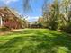 Expansive backyard with well-maintained lawn and mature landscaping, perfect for outdoor enjoyment at 3600 Castellaine Dr, Charlotte, NC 28226