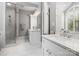 Bright bathroom with double vanities, quartz countertops, modern fixtures, and a glass-enclosed shower at 3600 Castellaine Dr, Charlotte, NC 28226