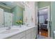 Bathroom featuring a double sink and mirror, with view to bedroom at 3600 Castellaine Dr, Charlotte, NC 28226
