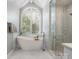Elegant bathroom with a luxurious freestanding tub, arched window, and separate glass-enclosed shower at 3600 Castellaine Dr, Charlotte, NC 28226