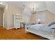 Spacious bedroom with hardwood floors, a desk area, and a cozy hanging chair for relaxation at 3600 Castellaine Dr, Charlotte, NC 28226