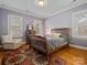 Bedroom with hardwood floors, a patterned rug, and plenty of natural light at 3600 Castellaine Dr, Charlotte, NC 28226