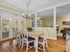 Inviting dining room with wood floors, chandelier, and decorative chairs next to the opening into the living room at 3600 Castellaine Dr, Charlotte, NC 28226