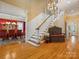 Spacious foyer featuring hardwood floors, a staircase, and views into the dining room and another living space at 3600 Castellaine Dr, Charlotte, NC 28226