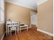 Hallway with hardwood floors leading to a well-lit room, offering a sense of space and flow at 3600 Castellaine Dr, Charlotte, NC 28226