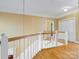 Bright hallway featuring hardwood floors and elegant white railings at 3600 Castellaine Dr, Charlotte, NC 28226