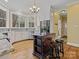 Charming kitchen featuring an island, white cabinetry, stainless steel appliances, and hardwood floors at 3600 Castellaine Dr, Charlotte, NC 28226