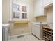Bright laundry room with a utility sink, built-in storage, and a window providing natural light at 3600 Castellaine Dr, Charlotte, NC 28226