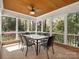 Covered patio featuring a ceiling fan, tile flooring, and outdoor seating at 3600 Castellaine Dr, Charlotte, NC 28226