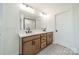 Bathroom with double vanity, wood cabinets, decorative tile floor, and large mirror at 3918 Dahlia Dr # 15, Harrisburg, NC 28075