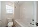 Modern bathroom featuring shower and tub with window and toilet at 3918 Dahlia Dr # 15, Harrisburg, NC 28075